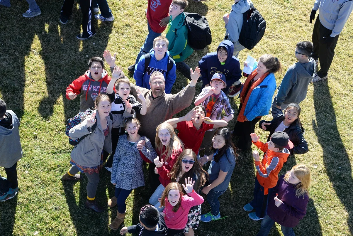 Dr. Chuck Buxbaum with students in a photo from a rented lift-chair on the West Field in 2014.